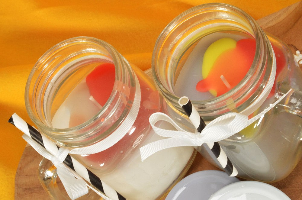 2x different POTTI SCENTED CANDLES in yellow, white, grey blue
